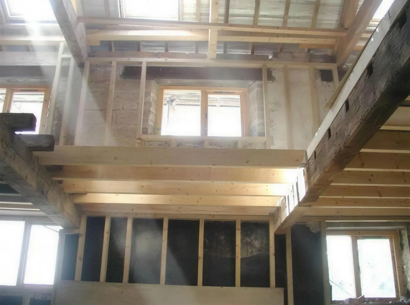Barn mid-conversion showing new floor structure between original stone walls