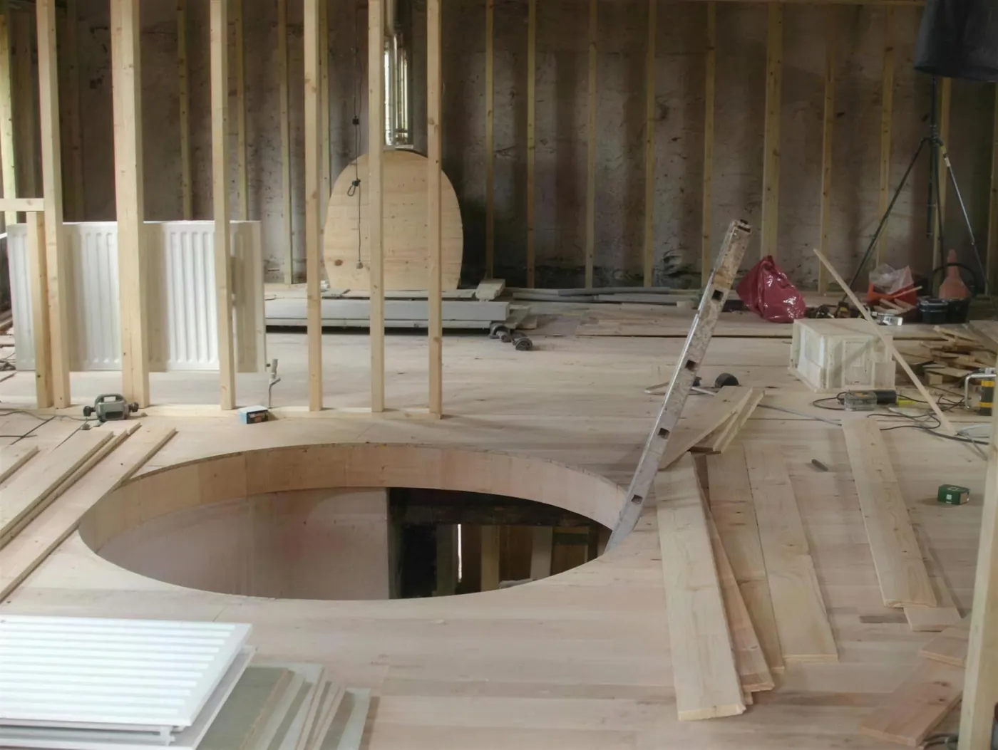 Circular opening cut through a first floor to receive a spiral staircase
