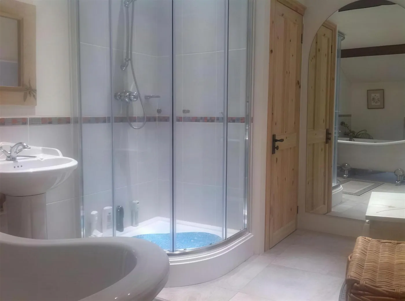 Quadrant shower enclosure and basin in a fitted bathroom