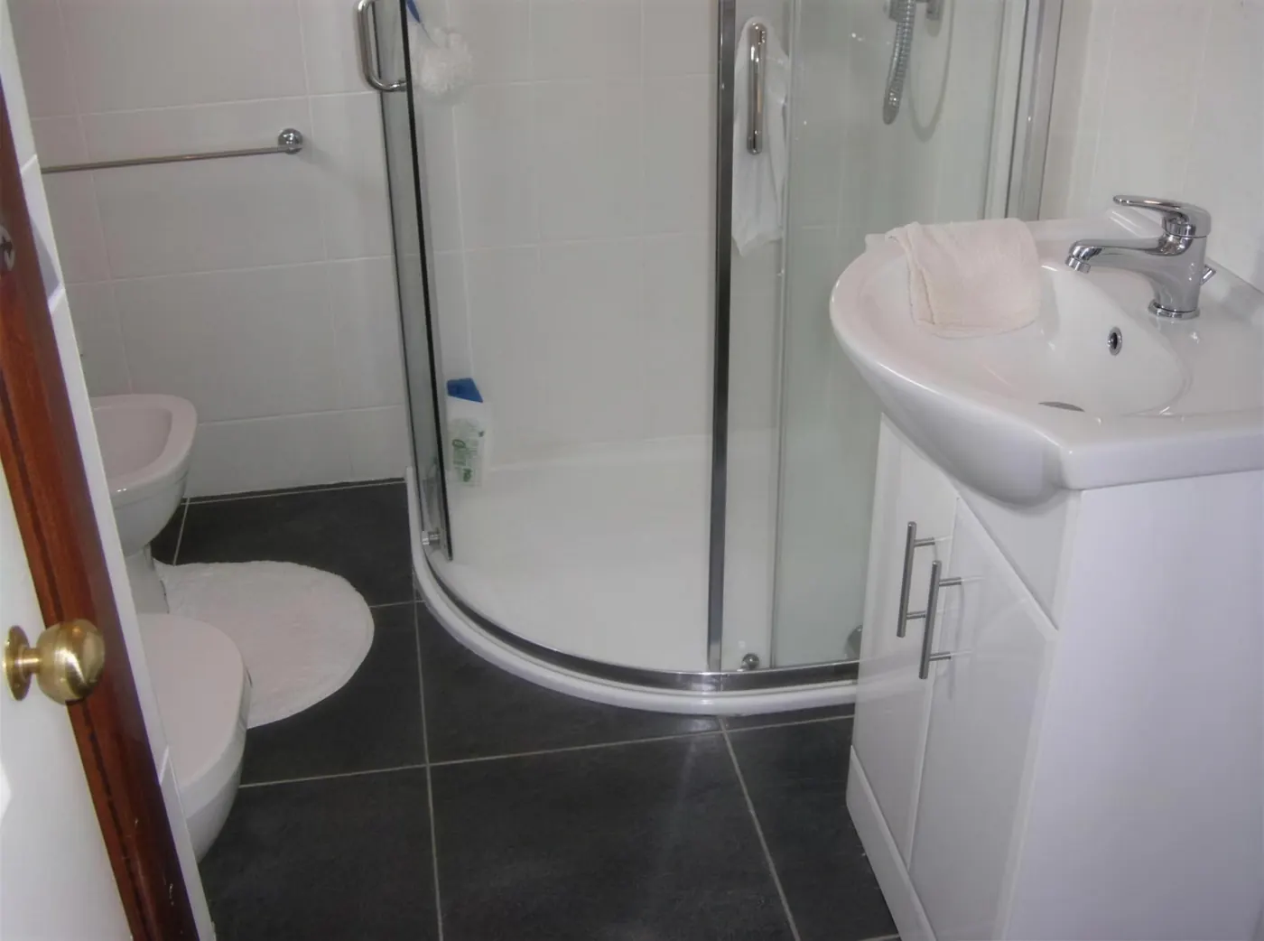 Small shower room with a quadrant enclosure and basin