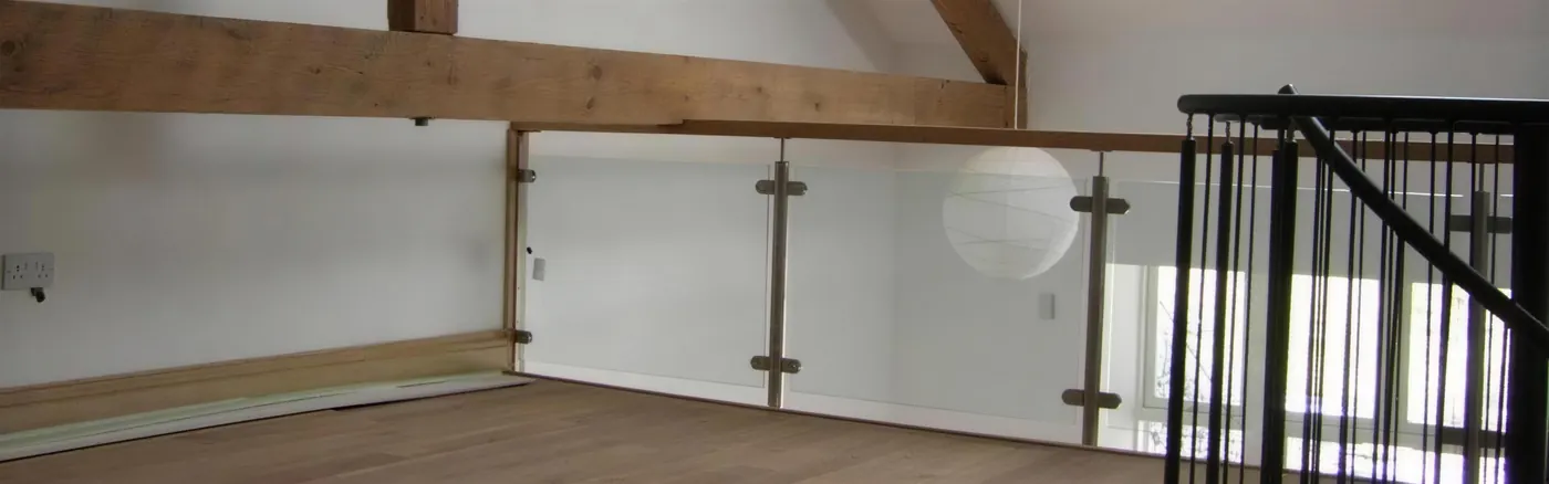 Completed loft conversion with oak trusses, timber floor and balustrade