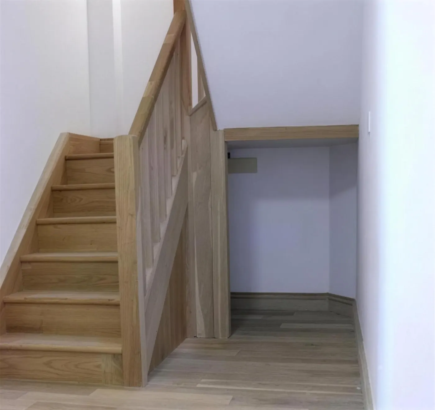 Bespoke timber staircase with panelled understair joinery